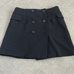 Women mini skirt featuring a double-breasted button front.